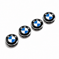 Set of four BMW 68mm floating wheel centre caps with blue and white emblems, black outer rings and chrome-effect edges in a presentation box