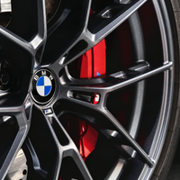 Set of four BMW 68mm floating wheel centre caps with blue and white emblems, black outer rings and chrome-effect edges in a presentation box